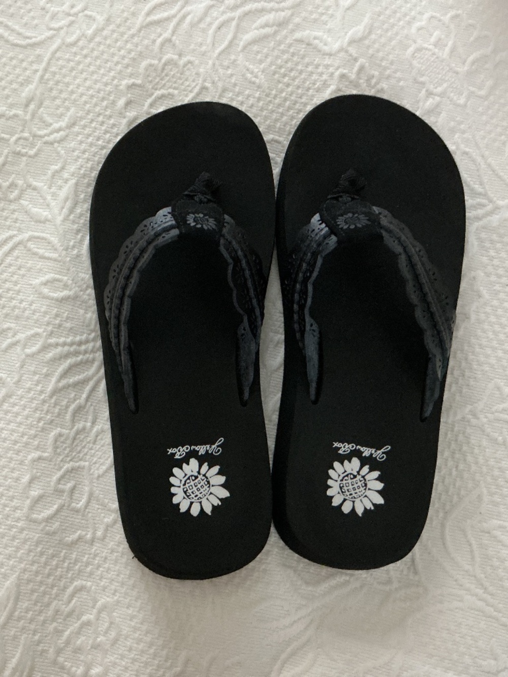 Yellow box flip flops in black